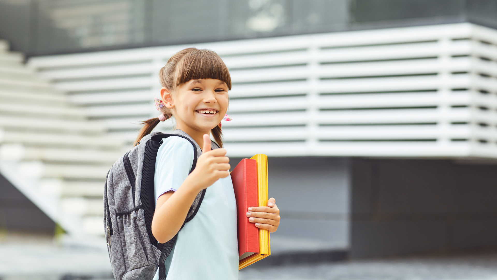 girl going back to school with a thumbs up